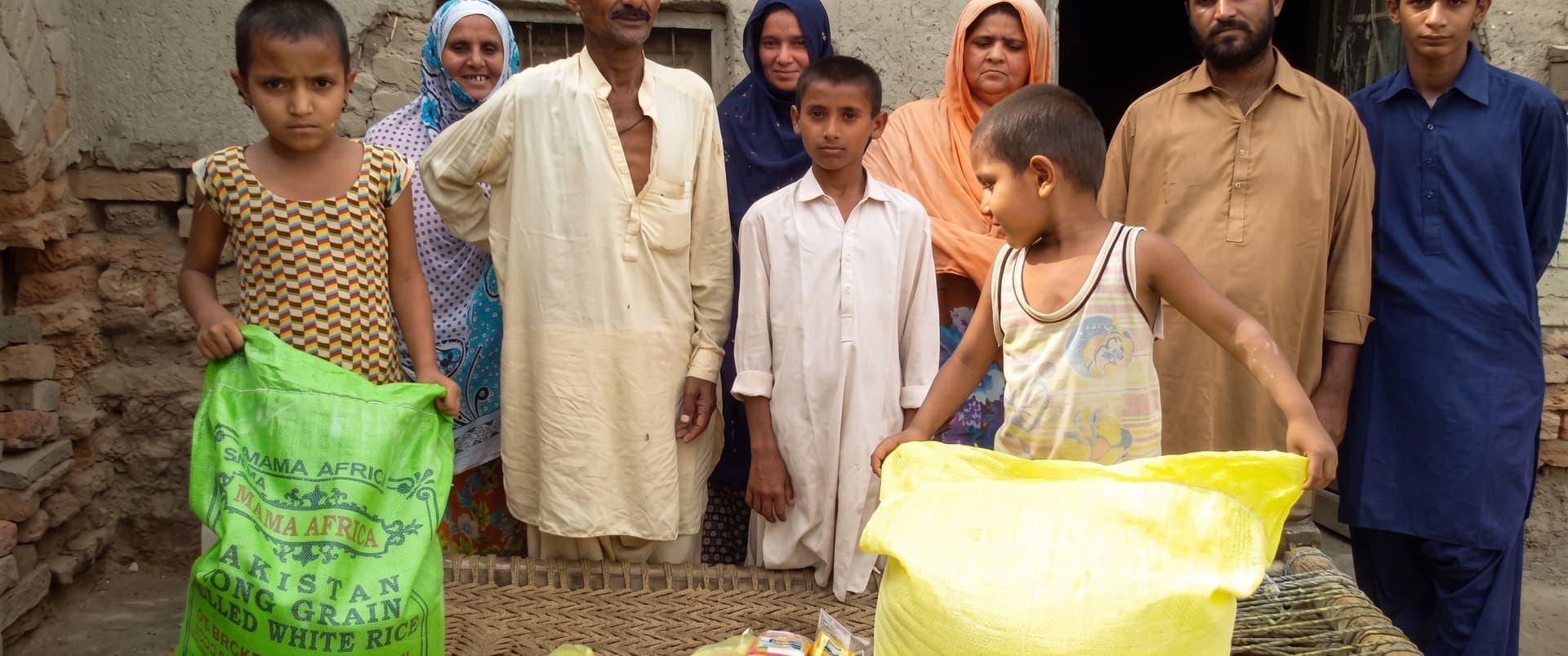 A family in rural Sindh receiving food rations from the Trust